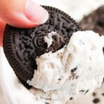 hand with Oreo and Oreo cheesecake dip and recipe name overlay