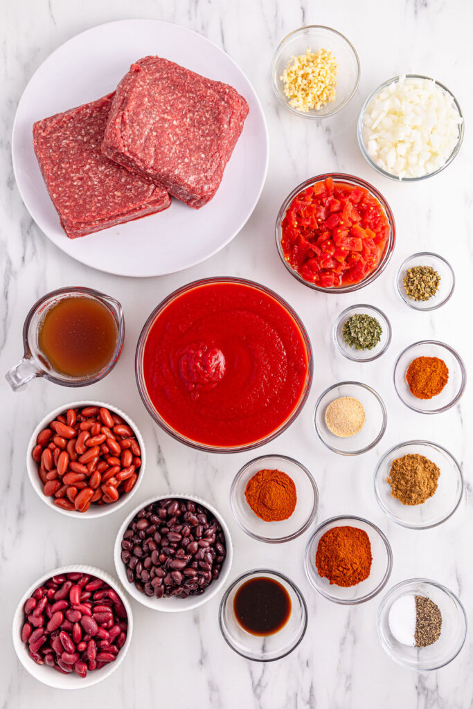 slow cooker chili ingredients in bowls on countertop