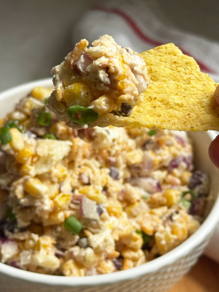 tortilla chip with cowboy corn dip on it
