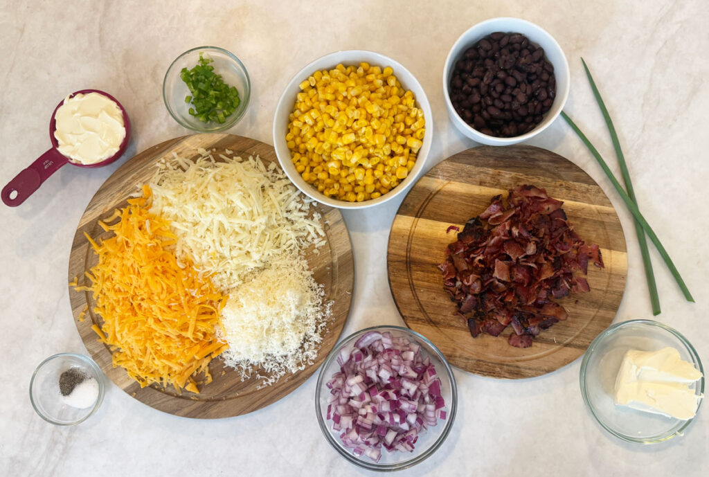 cowboy corn dip ingredients in bowls on counter