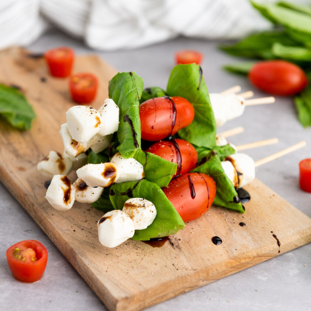 caprese skewers on cutting board