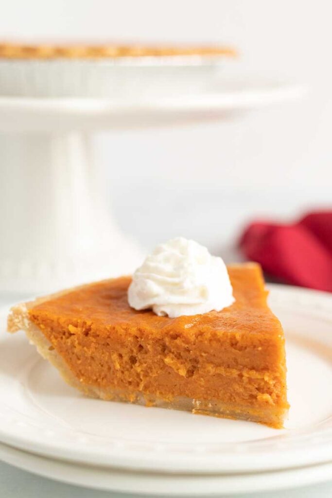 slice of pumpkin pie on white plate