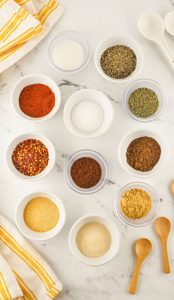 Jamaican jerk seasoning ingredients in white bowls on countertop