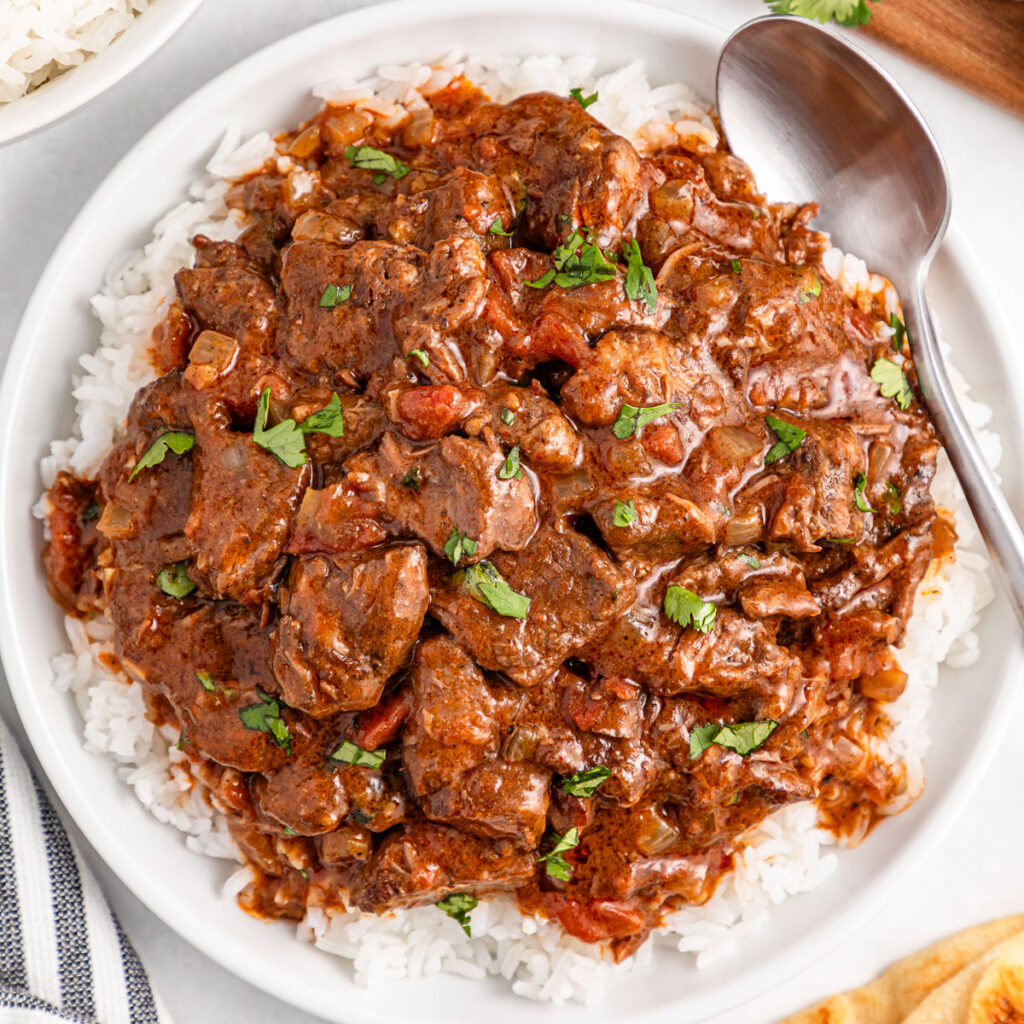 plate of slow cooker beef curry over rice