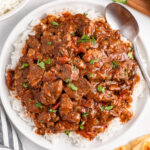 plate of slow cooker beef curry over rice