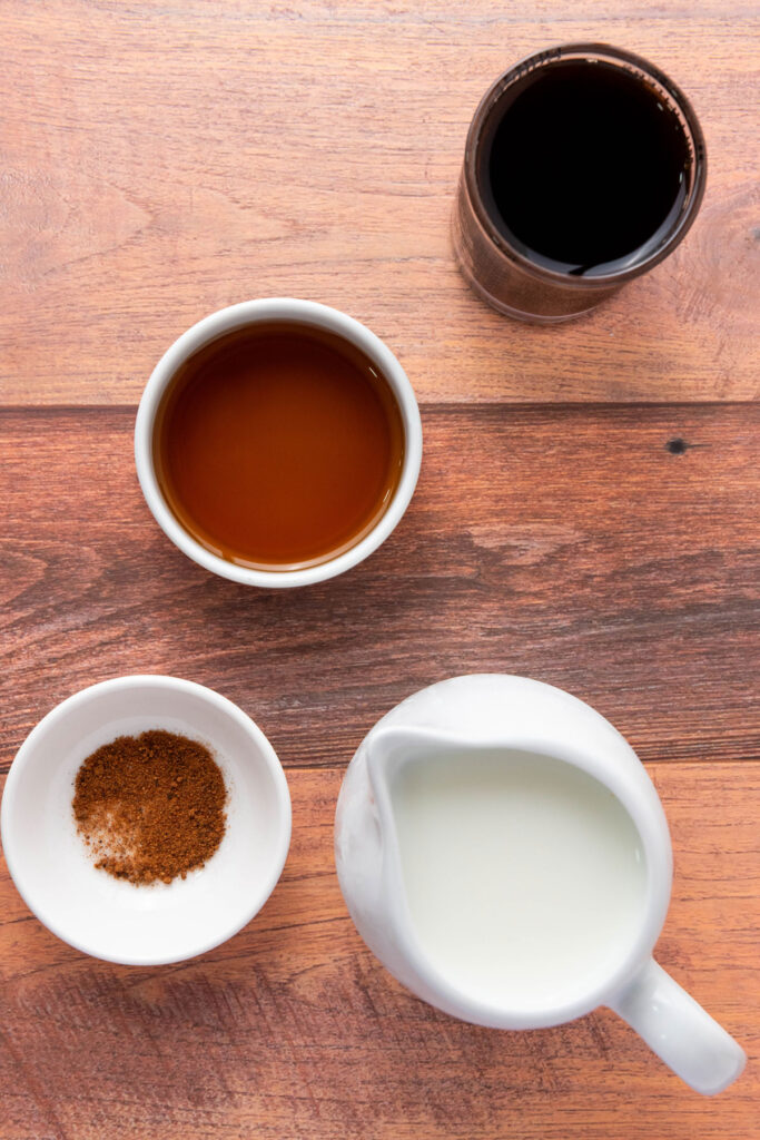 gingerbread latte ingredients on wooden countertop