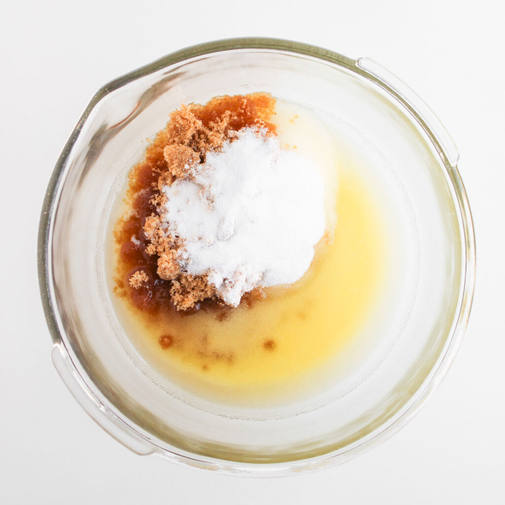 brown sugar, sugar, and melted butter in glass bowl