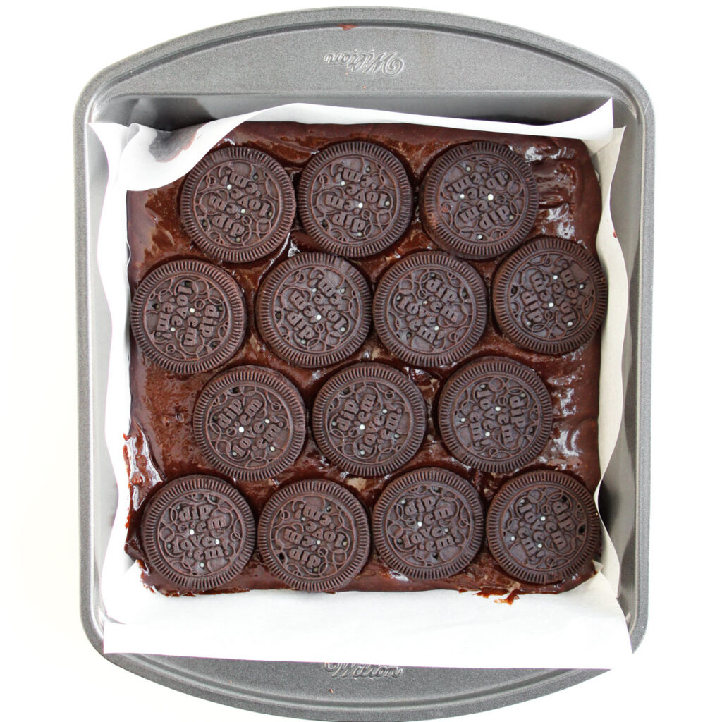 brownie batter with oreos layered on top