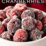 close up of sugared cranberries in white ramekin with recipe name overlay