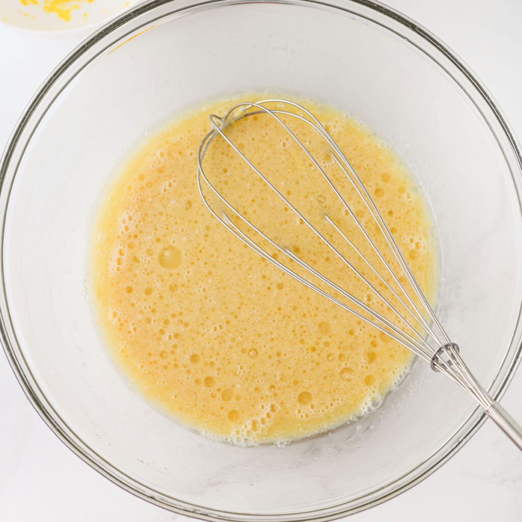mixing batter for cranberry orange muffins