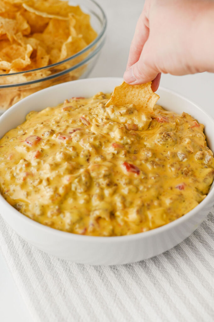 dipping corn chip into football dip