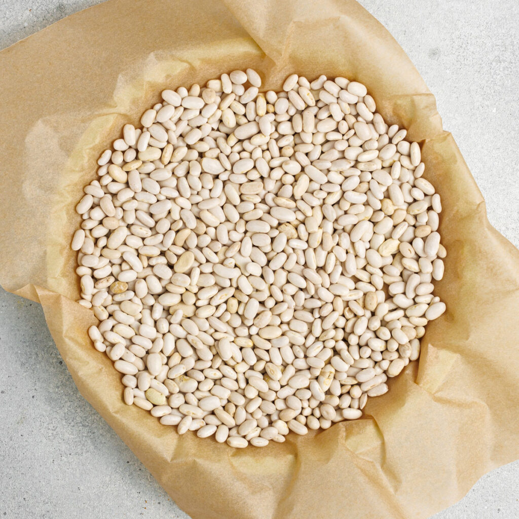 beans over parchment paper in pie crust