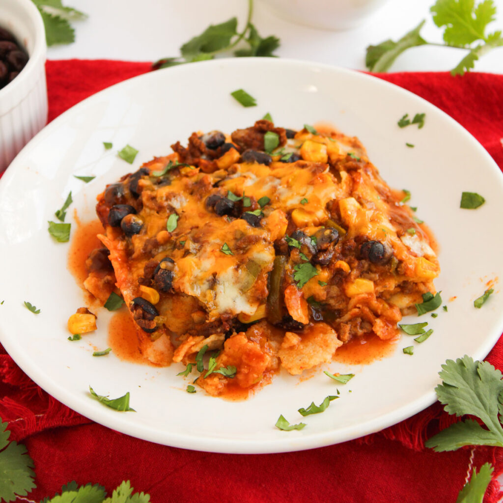 serving of enchilada casserole on white plate