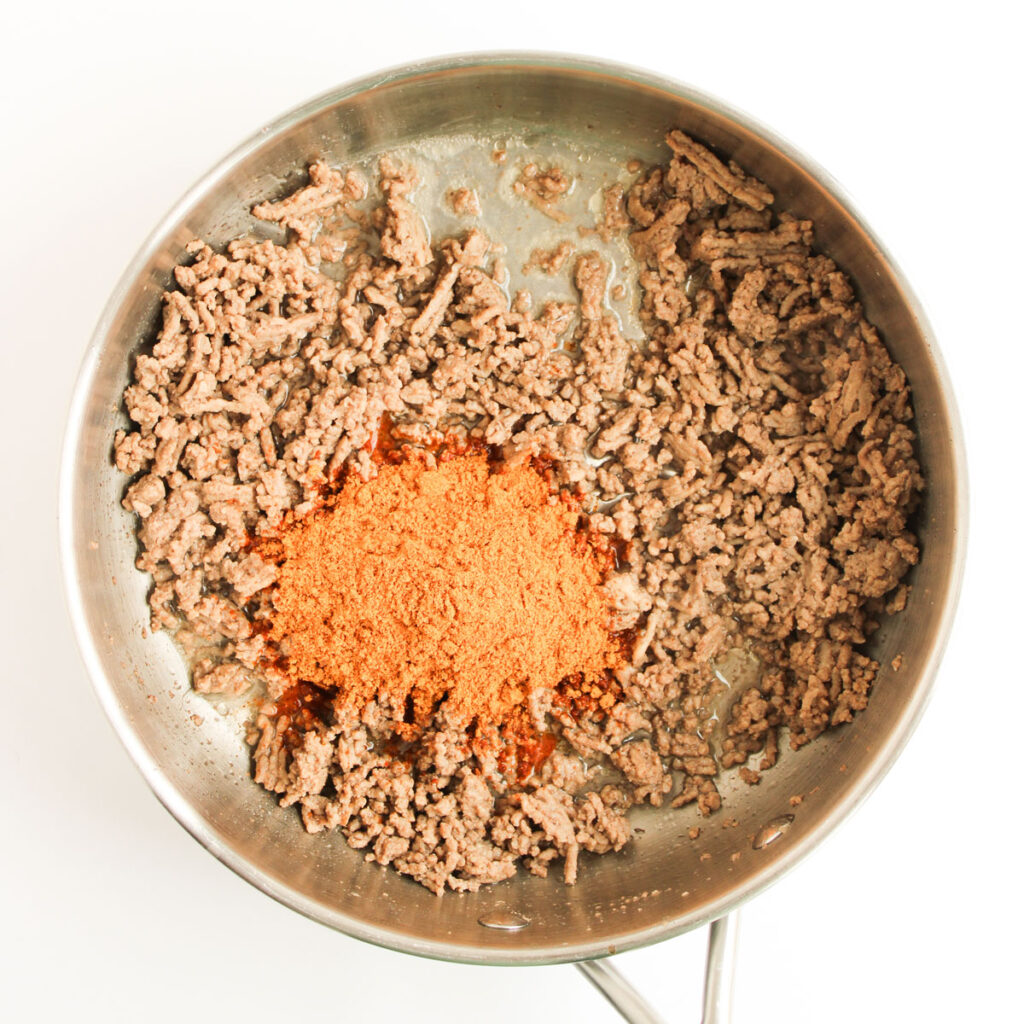 ground beef and seasoning in skillet for enchilada casserole