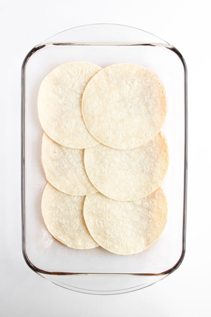 tortillas in casserole dish for enchilada casserole