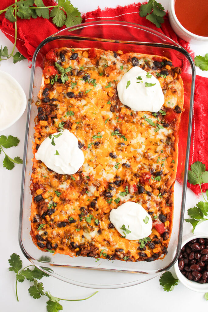 enchilada casserole with sour cream and cilantro on top