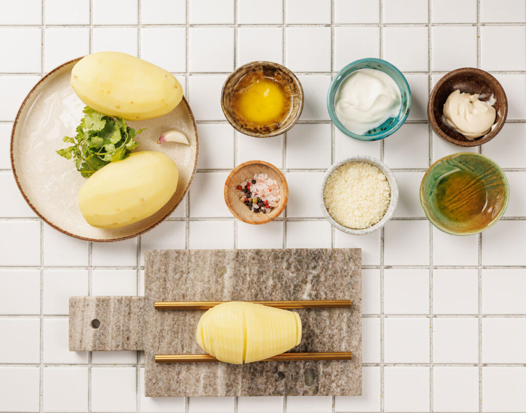 hasselback potatoes ingredients on tiled countertop