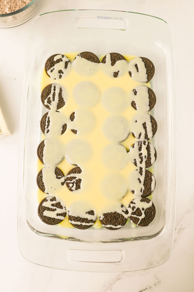 process photo of layering oreo dump cake