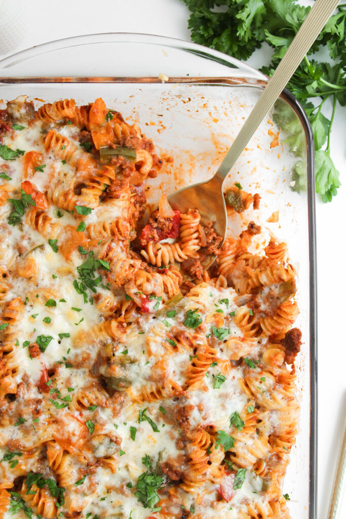 spoon scooping stuffed pepper casserole from casserole dish