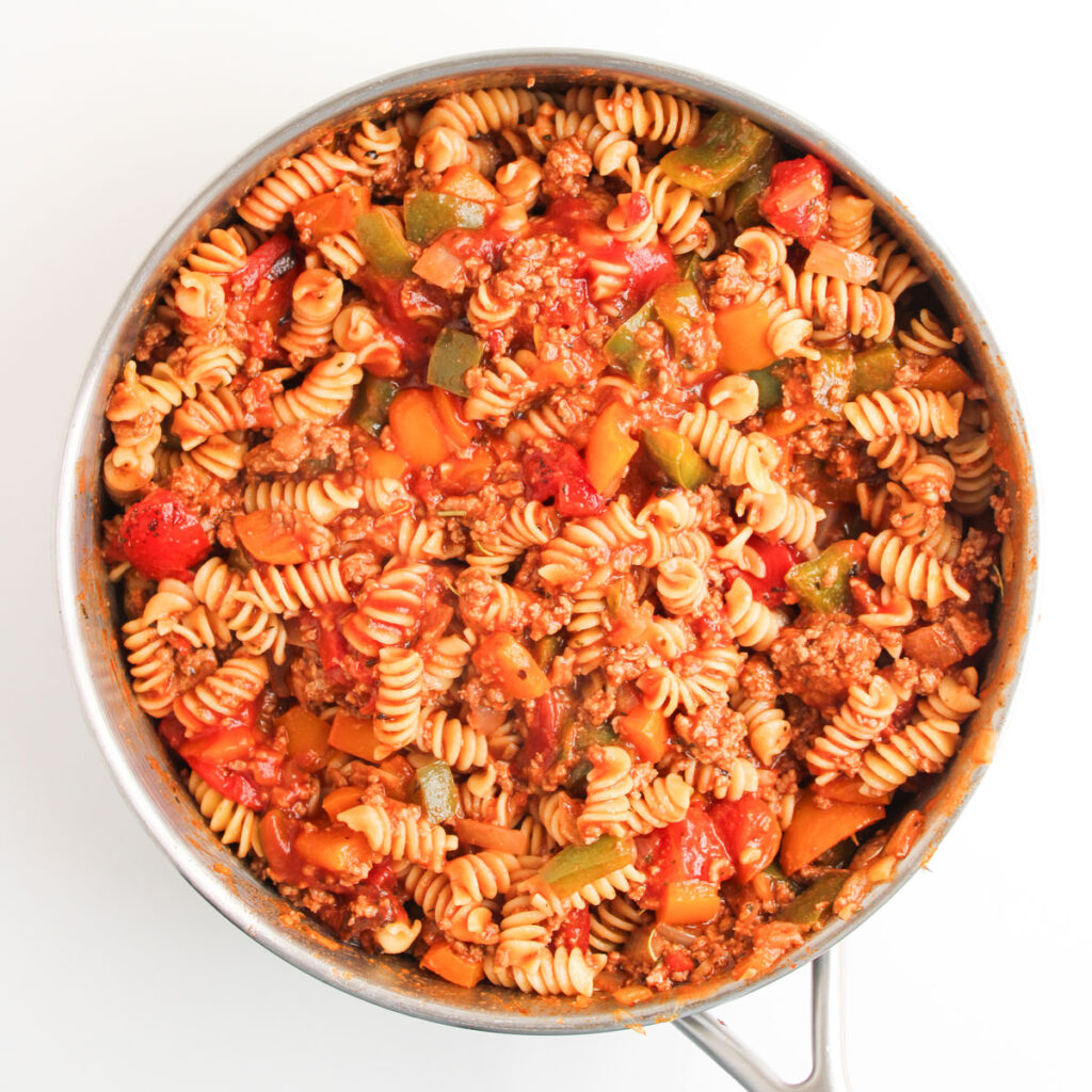 pasta and veggies in pan for making stuffed pepper casserole