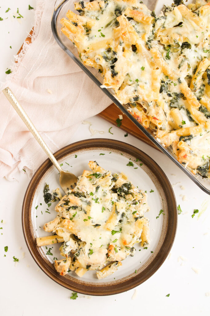 plate of spinach Artichoke Chicken Casserole with casserole dish in background