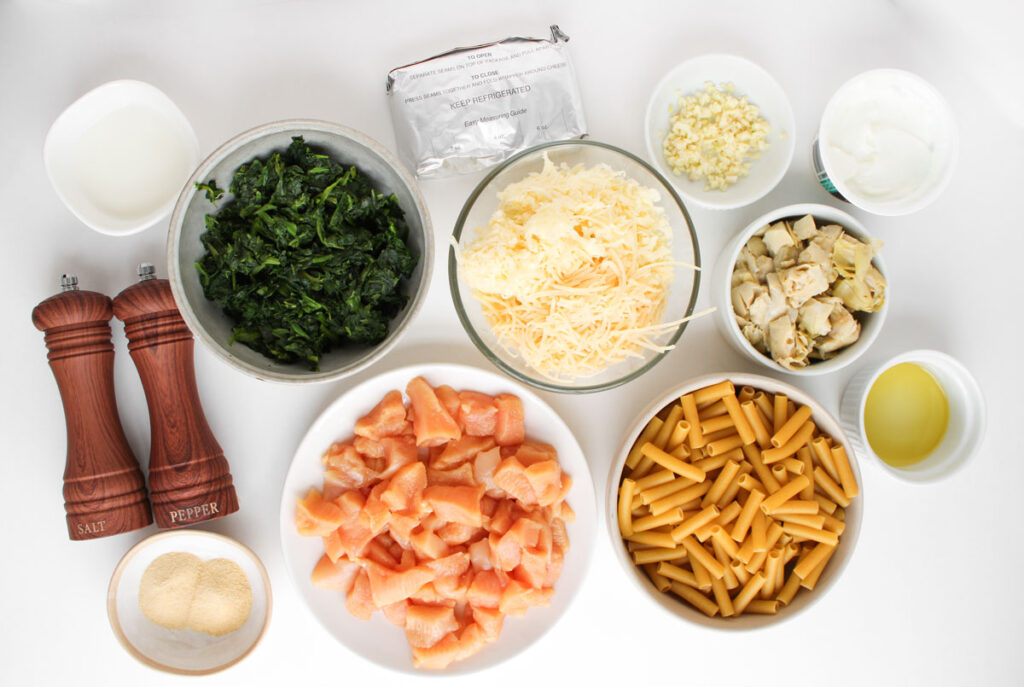 spinach Artichoke Chicken Casserole ingredients in bowls on countertop