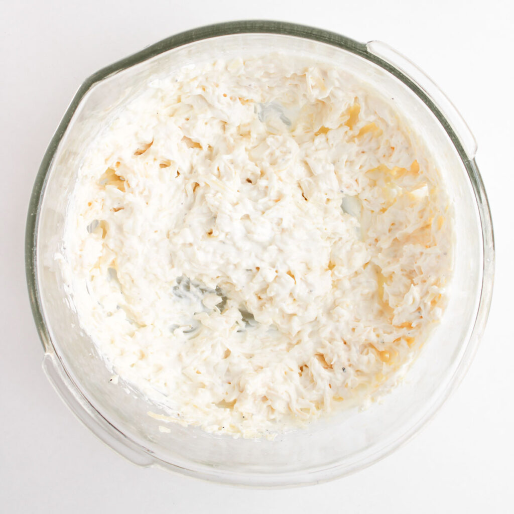 cheese mixture for spinach Artichoke Chicken Casserole in glass bowl