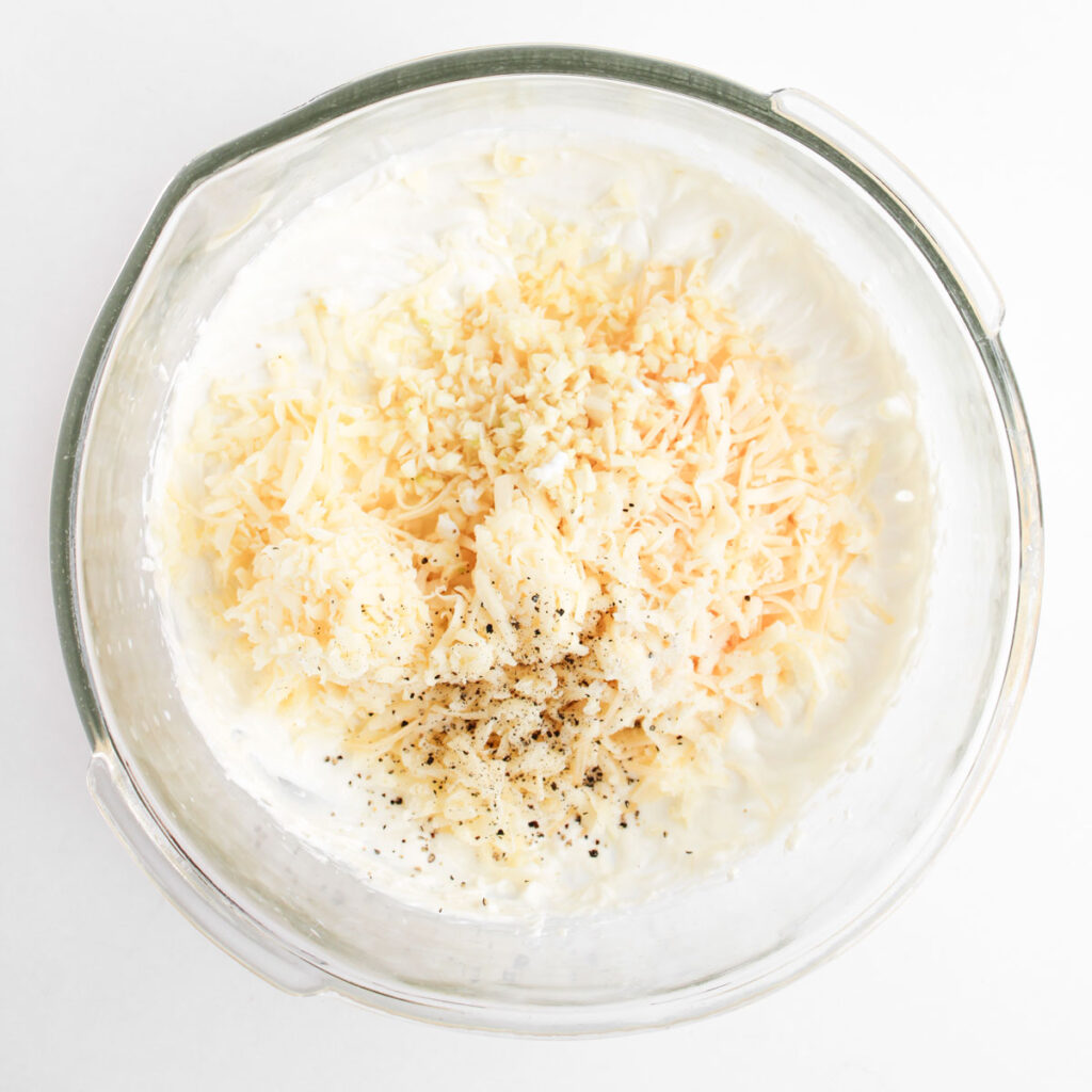 cheese mixture for spinach Artichoke Chicken Casserole in glass bowl