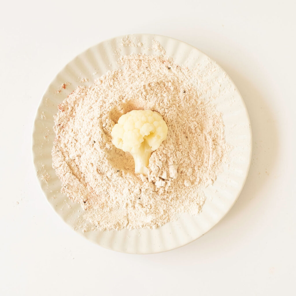 cauliflower bite in seasoned flour