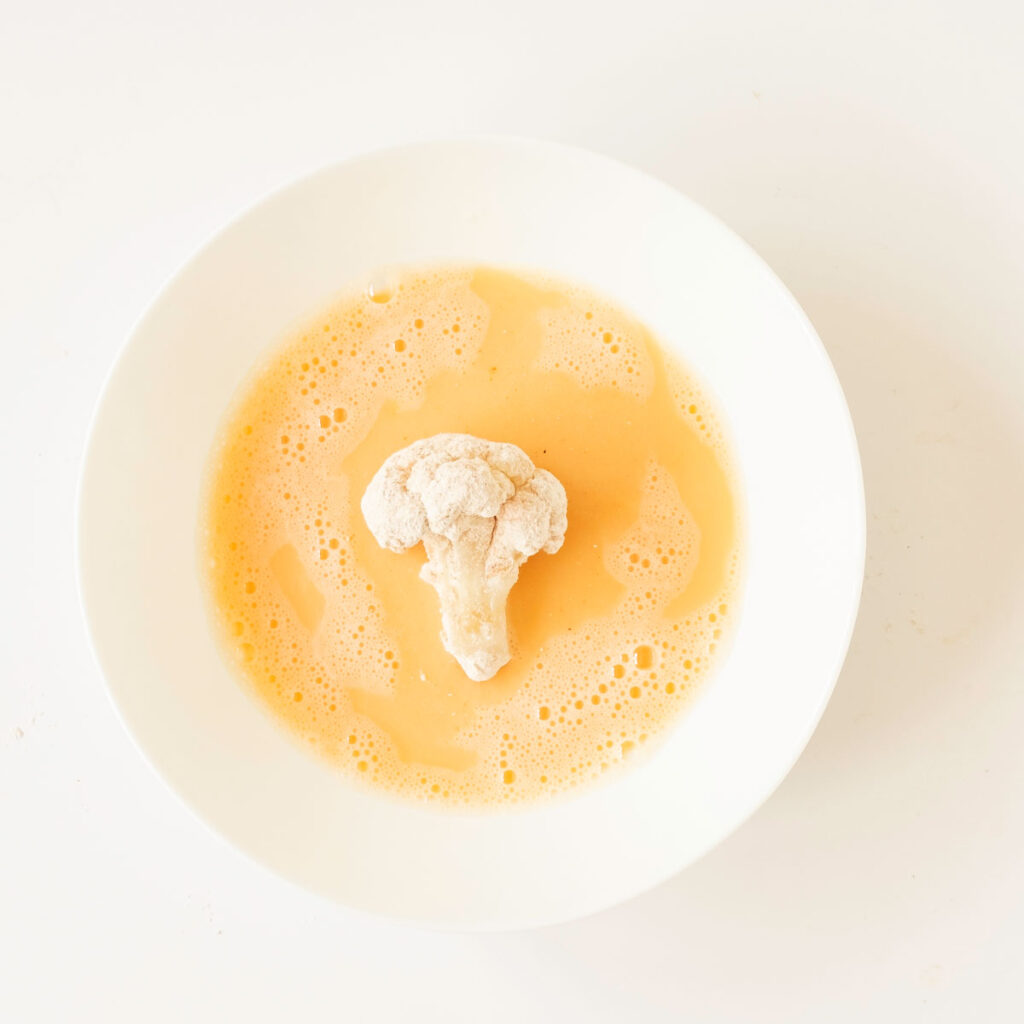 cauliflower bite in egg mixture