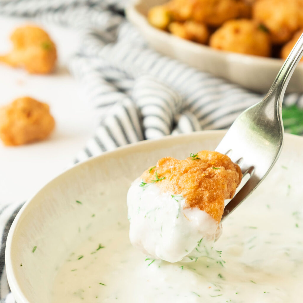 fork with crispy cauliflower bite and white sauce