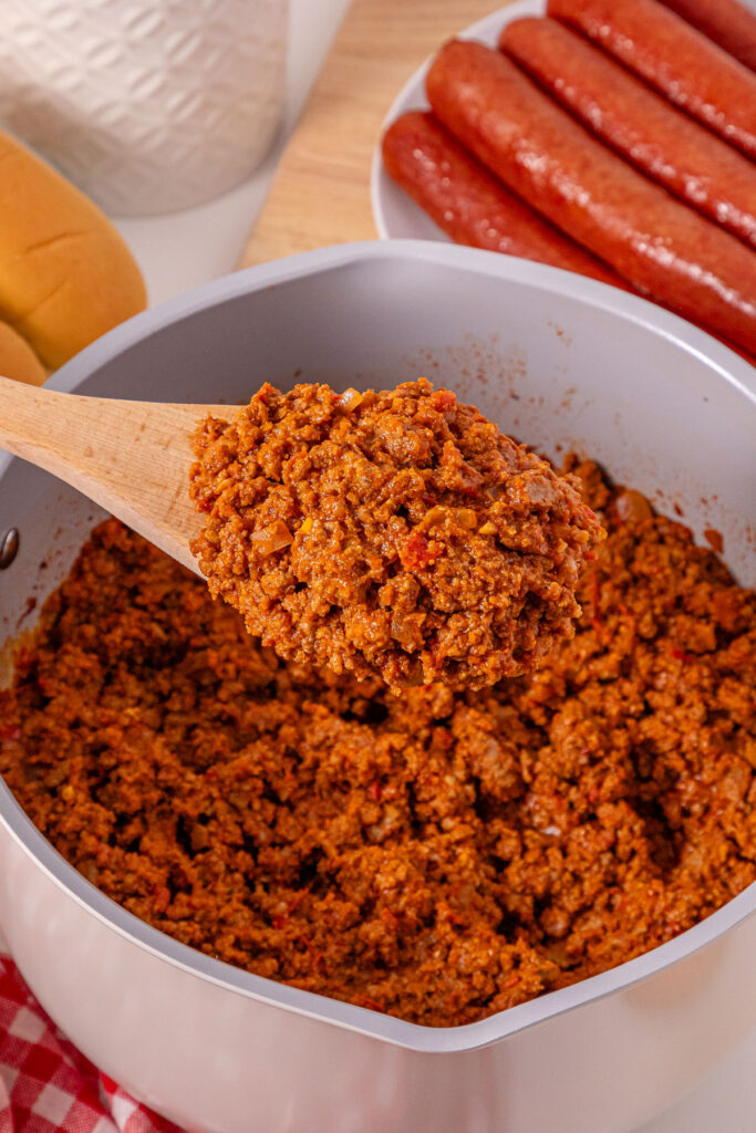 scooping hot dog chili from pot