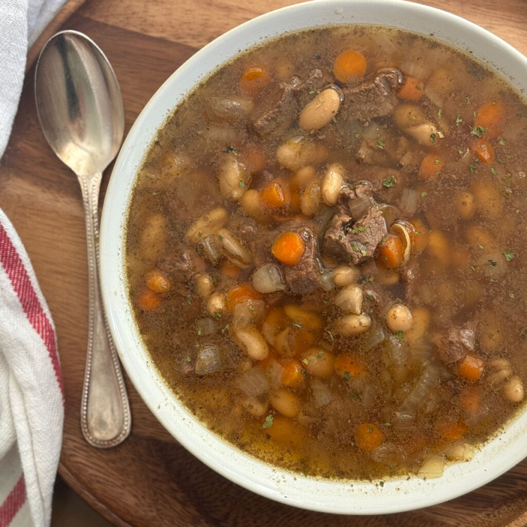 beef and bean soup in white bowl