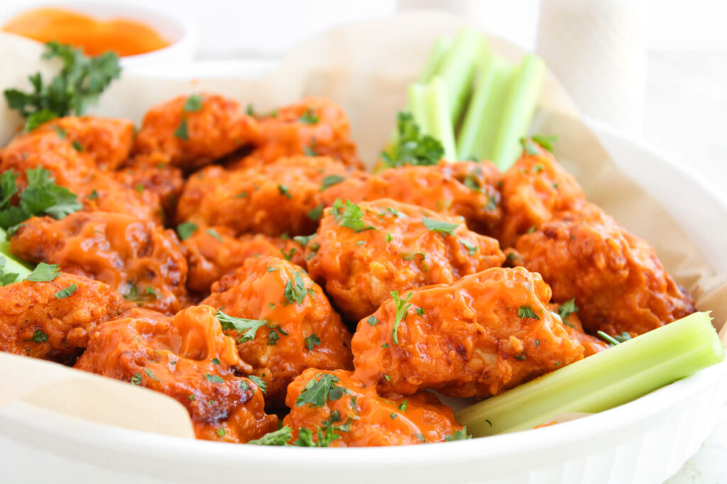 boneless buffalo wings and celery in plate