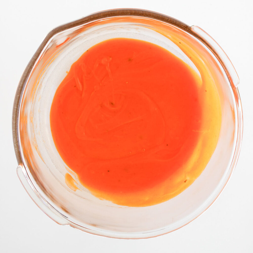 buffalo sauce in glass bowl