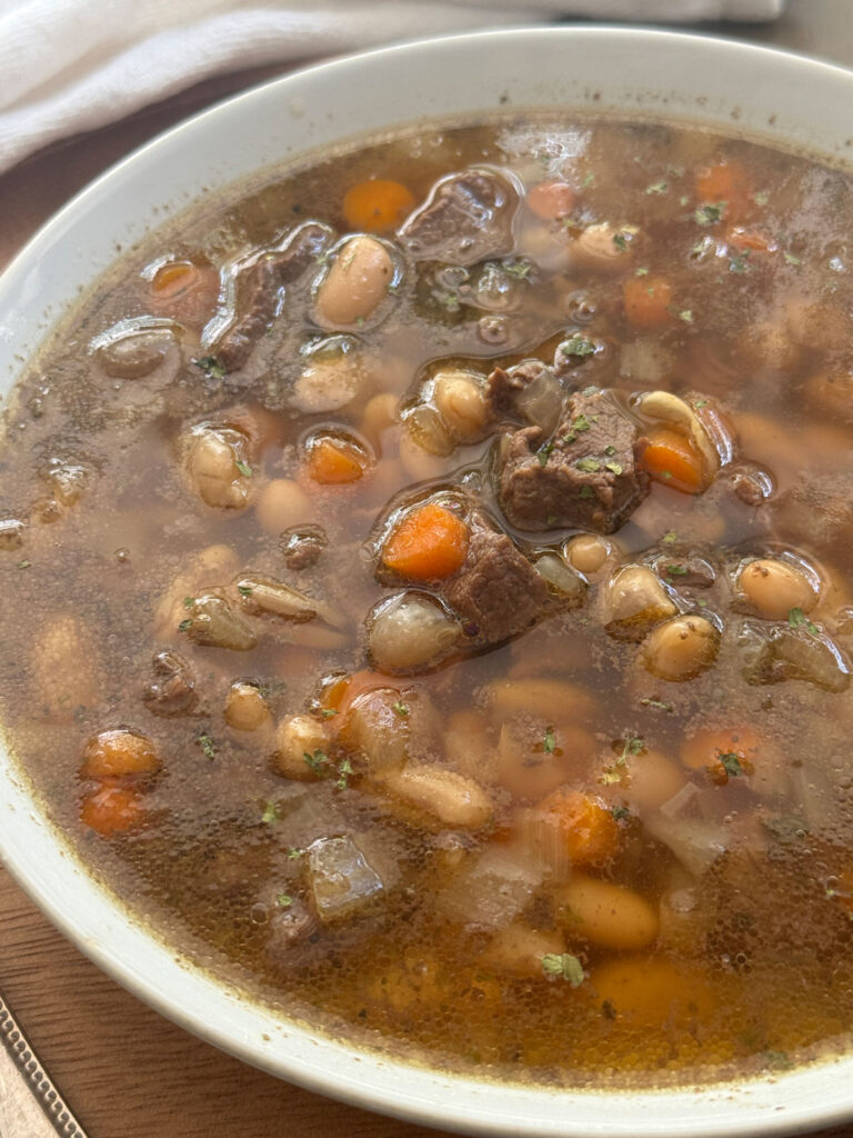 beef and bean soup in white bowl