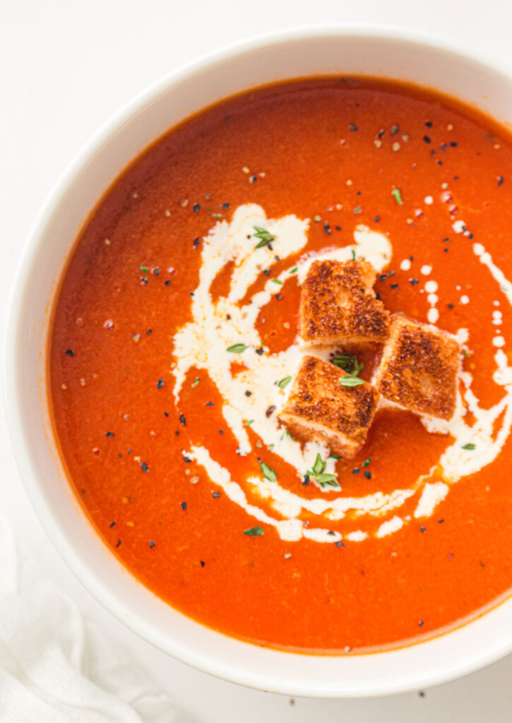 tomato soup with cream drizzle and croutons