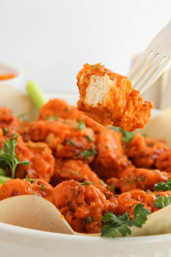 boneless buffalo wings with one bitten into