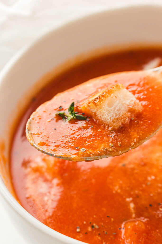 spoonful of tomato soup over bowl